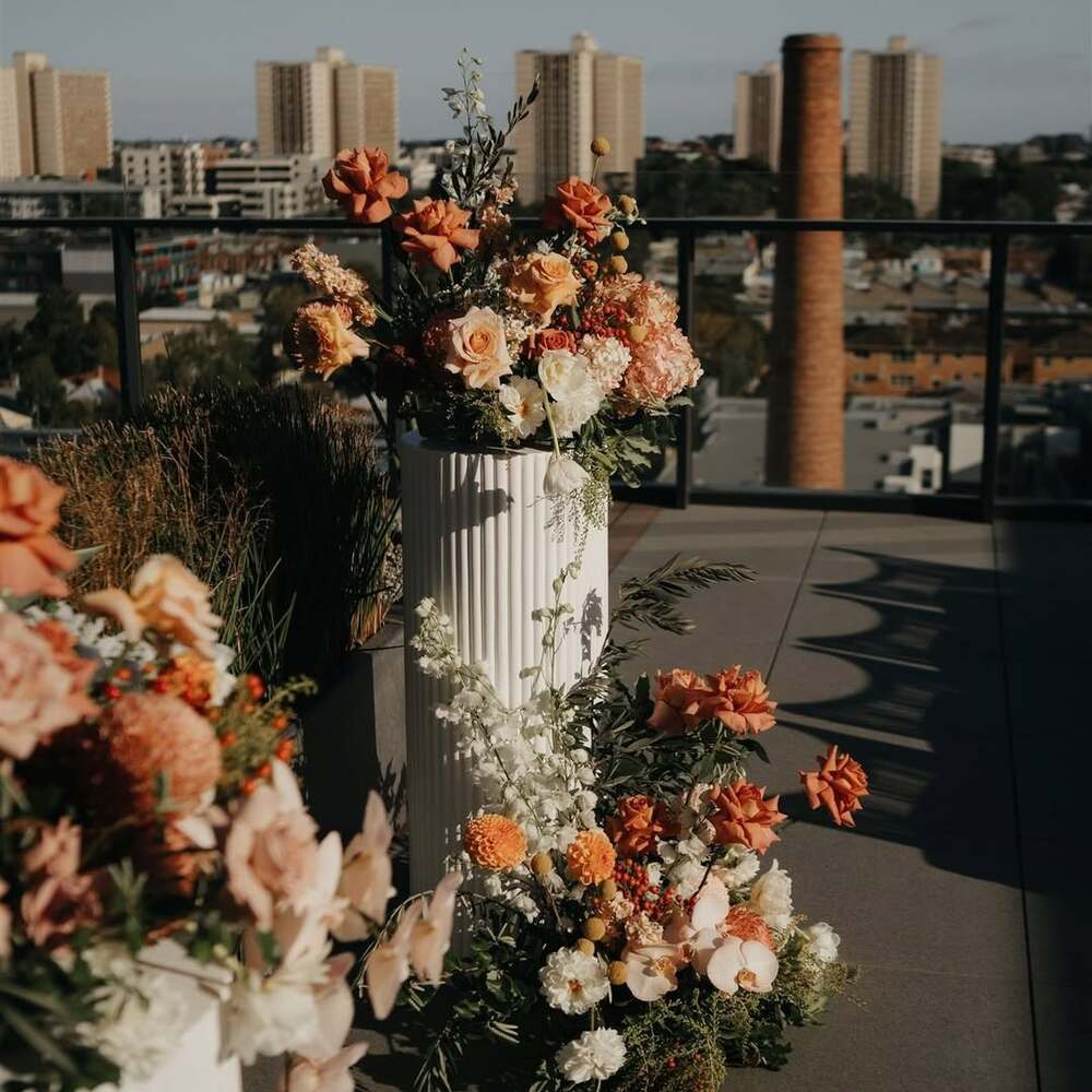 Terrace wedding decor with autumnal flower pillars
