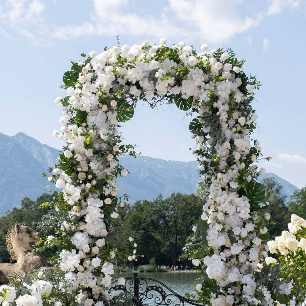 White floral arch with mountain view