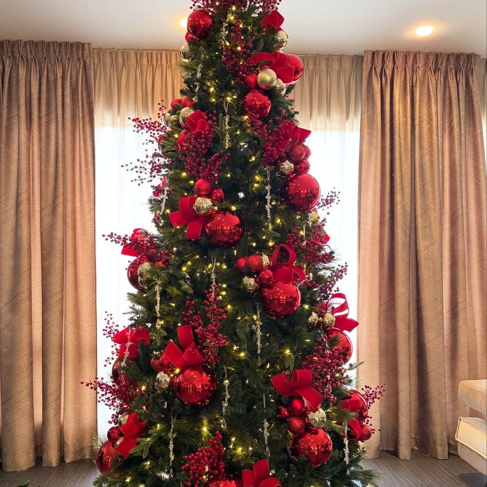 Tall Christmas tree with red decorations