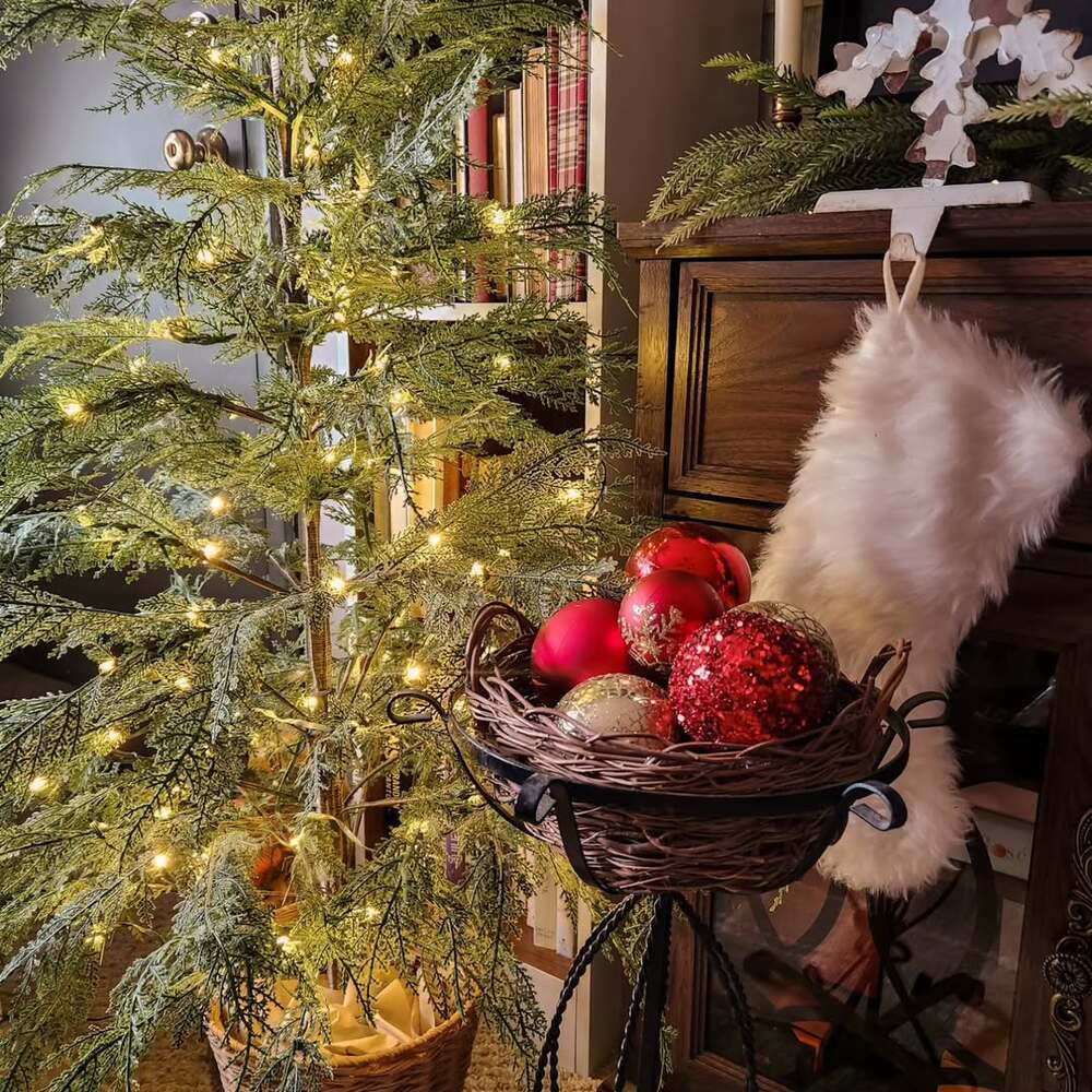 Cozy lit Christmas tree and ornaments