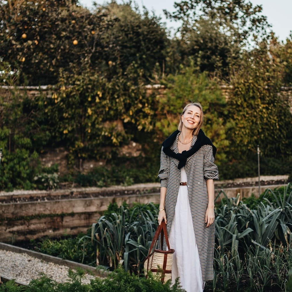 Woman smiling in a lush garden
