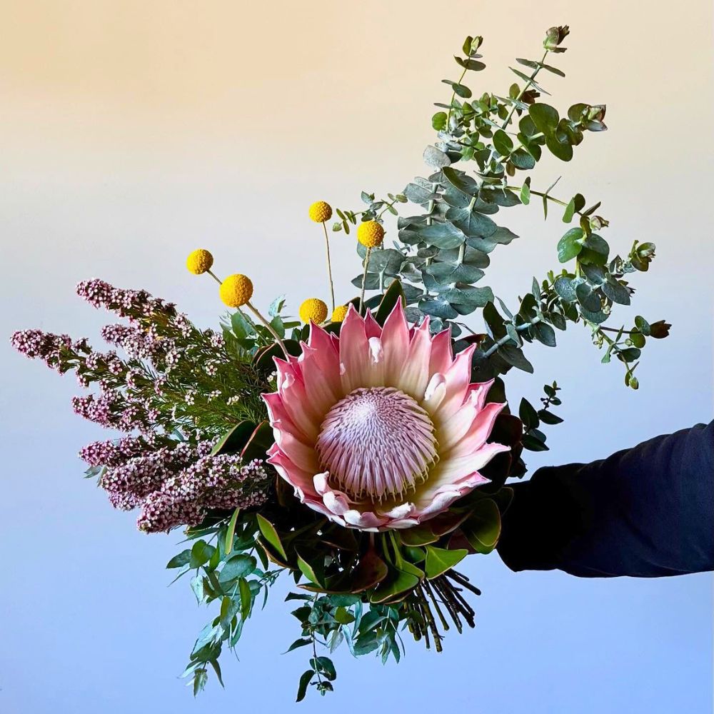 a mixed bouquet featuring the protea - protea is also one of those flowers that represent strength