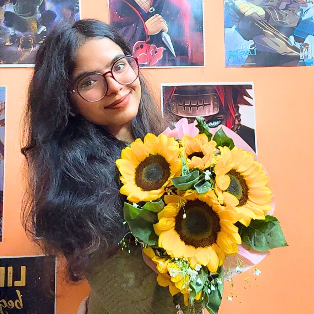 A lady holding a bunch of sunflowers