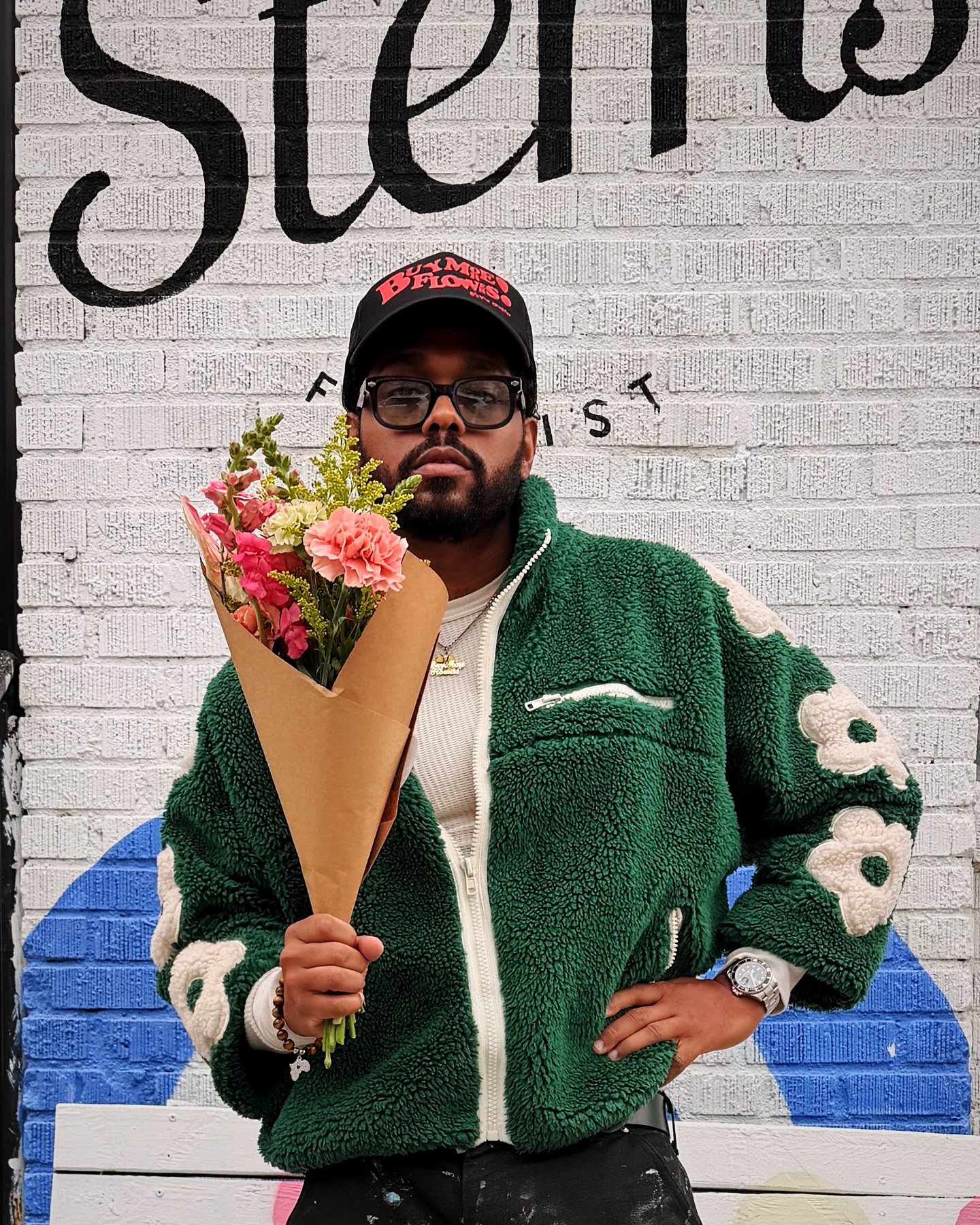 a man holding a bouquet from Stems Brooklyn NYC