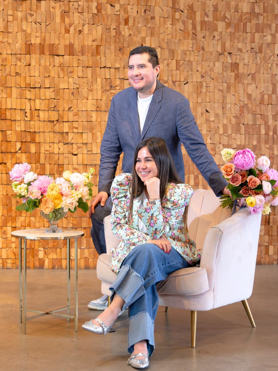 Owners of Carlota posing with flowers