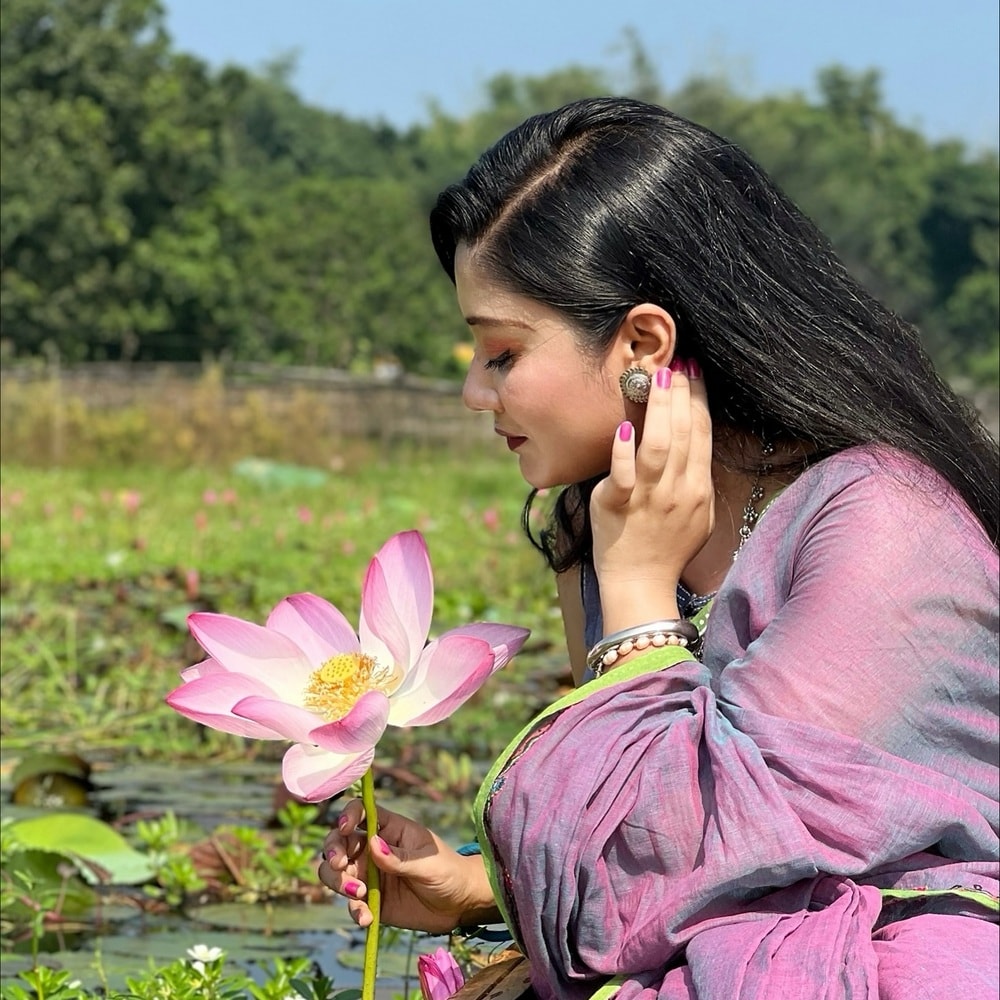 Woman holding pink water lily