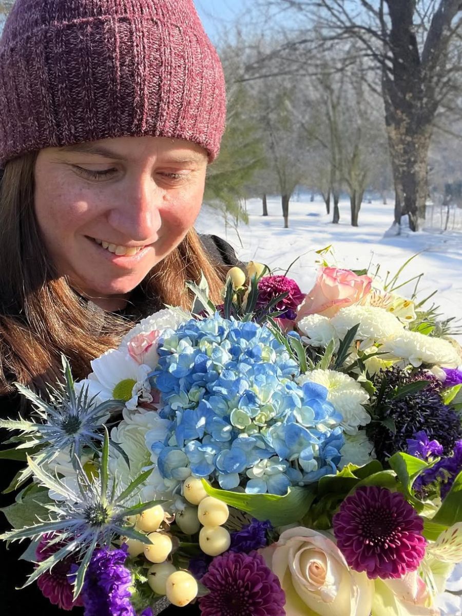 Woman with flowers in snowy weather