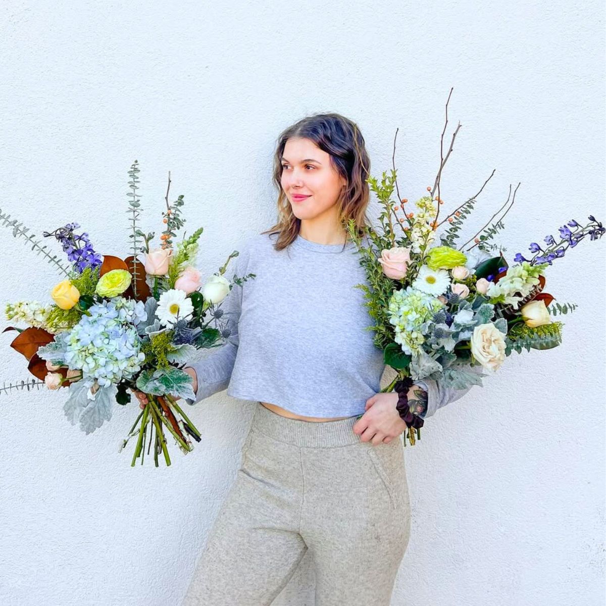 Two floral bouquets held by a girl