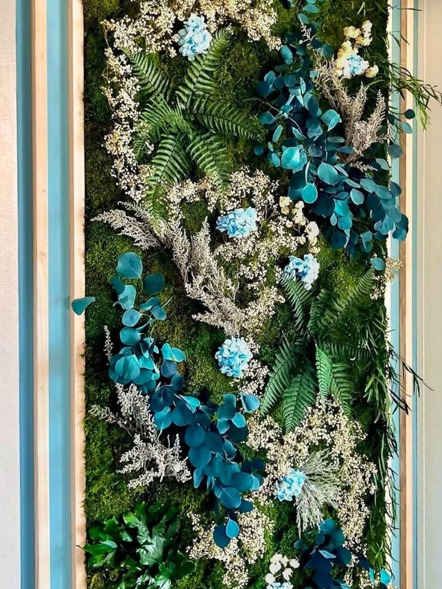 A wall made of preserved flowers and foliage