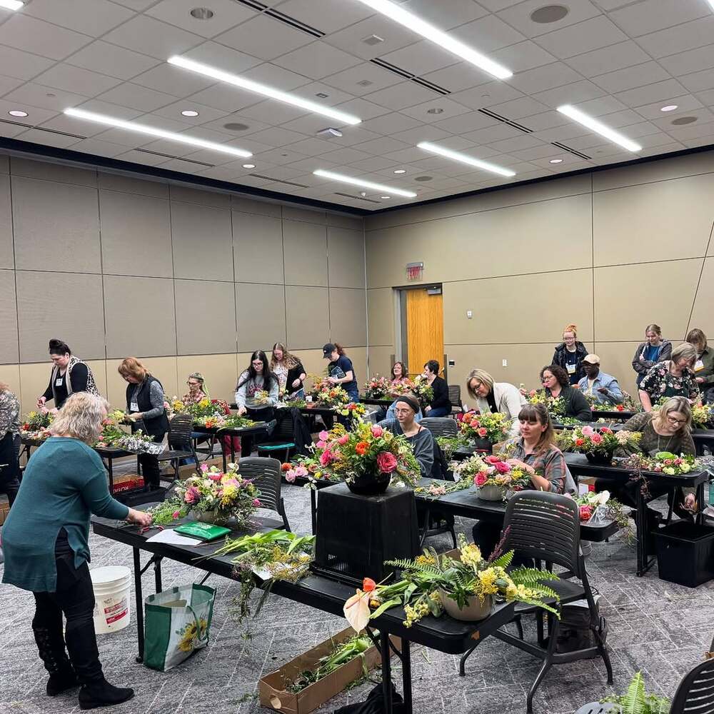 Floral workshop participants creating arrangements