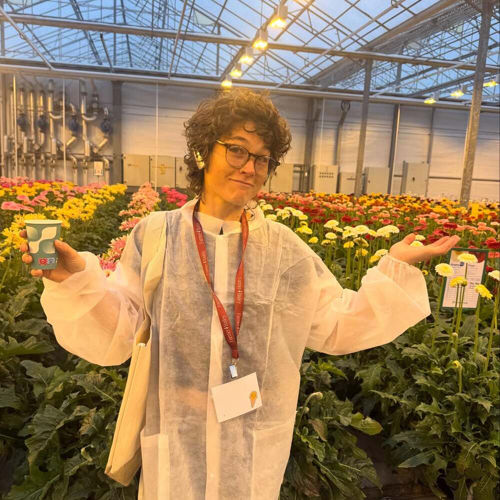 Professional florist touring flower greenhouse