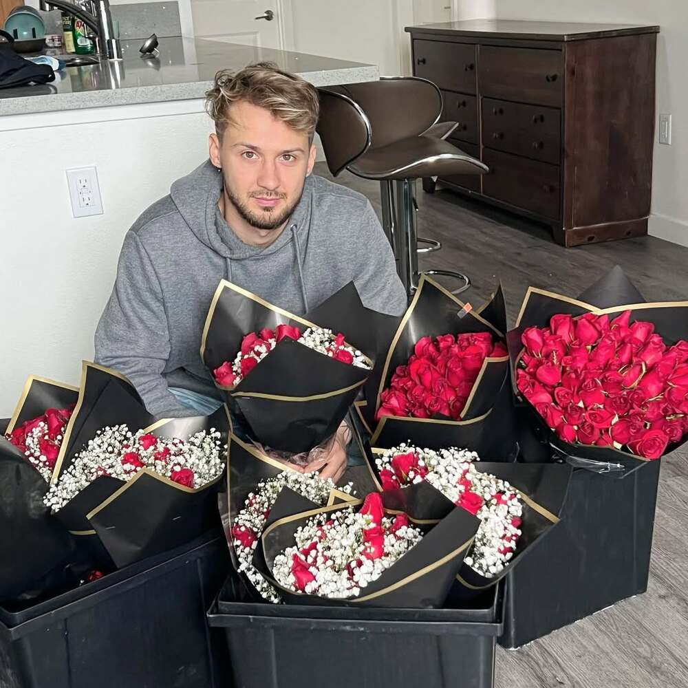 Man posing with rose bouquets
