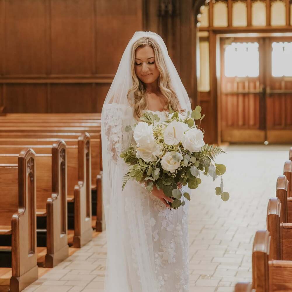 Bride holding white floral bouquet