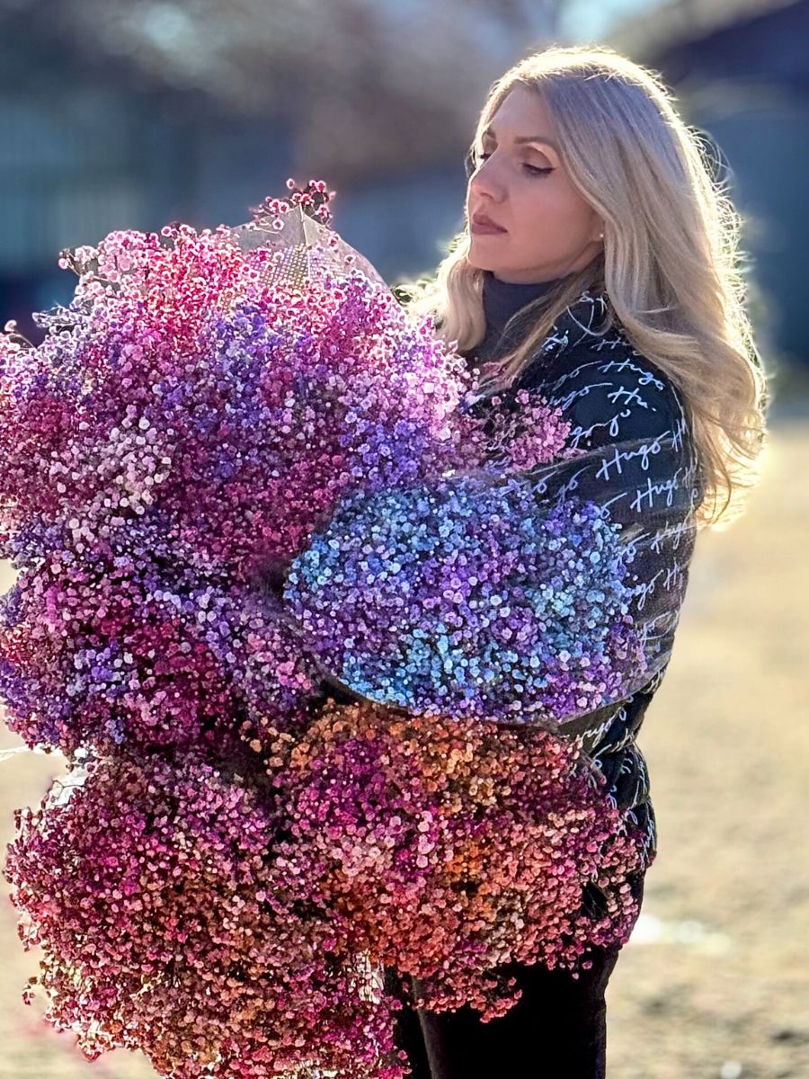 Alina Neacsa holding bunches of tinted gypsophila