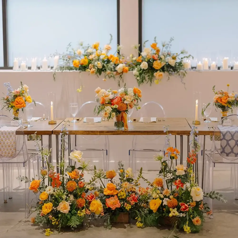Orange floral arrangements on wedding table