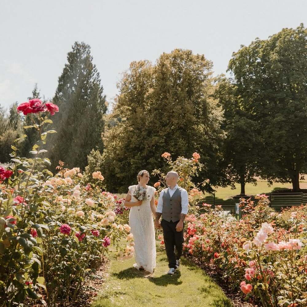 Couple walking through blooming garden
