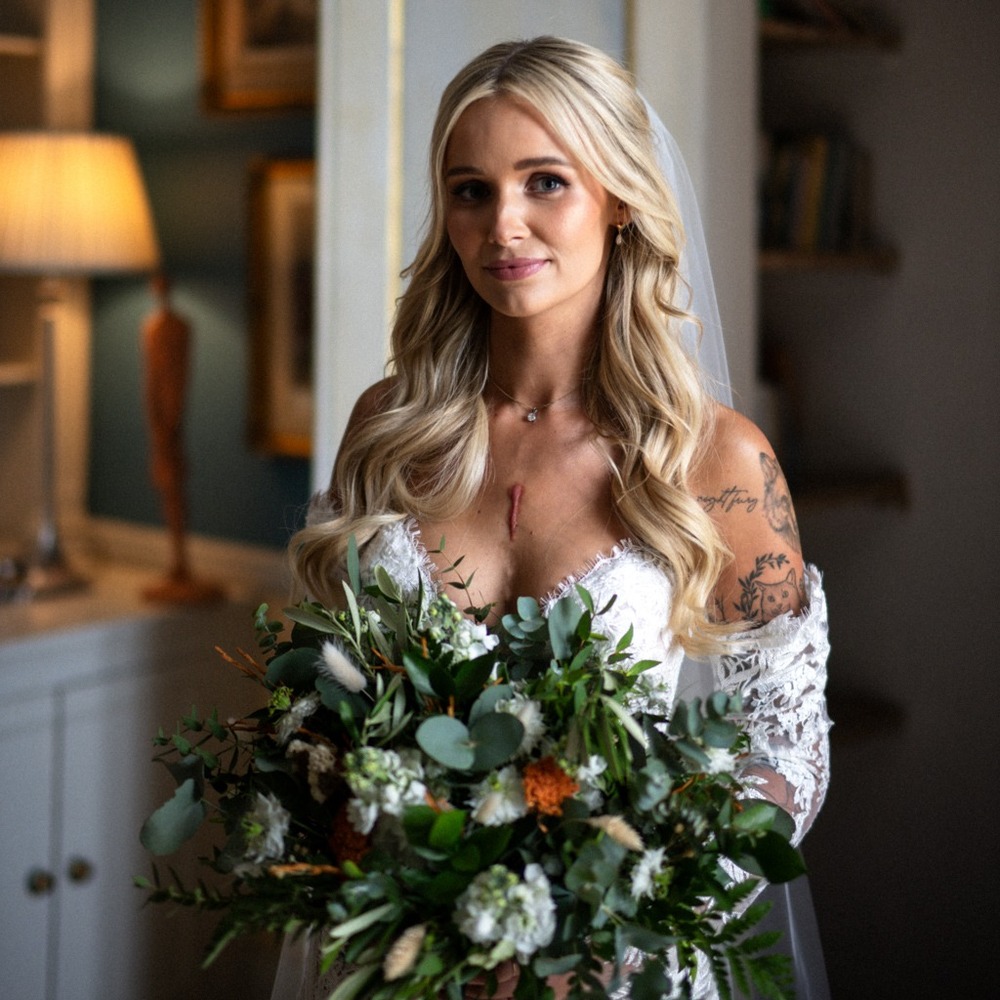Bride holding lush green wedding bouquet