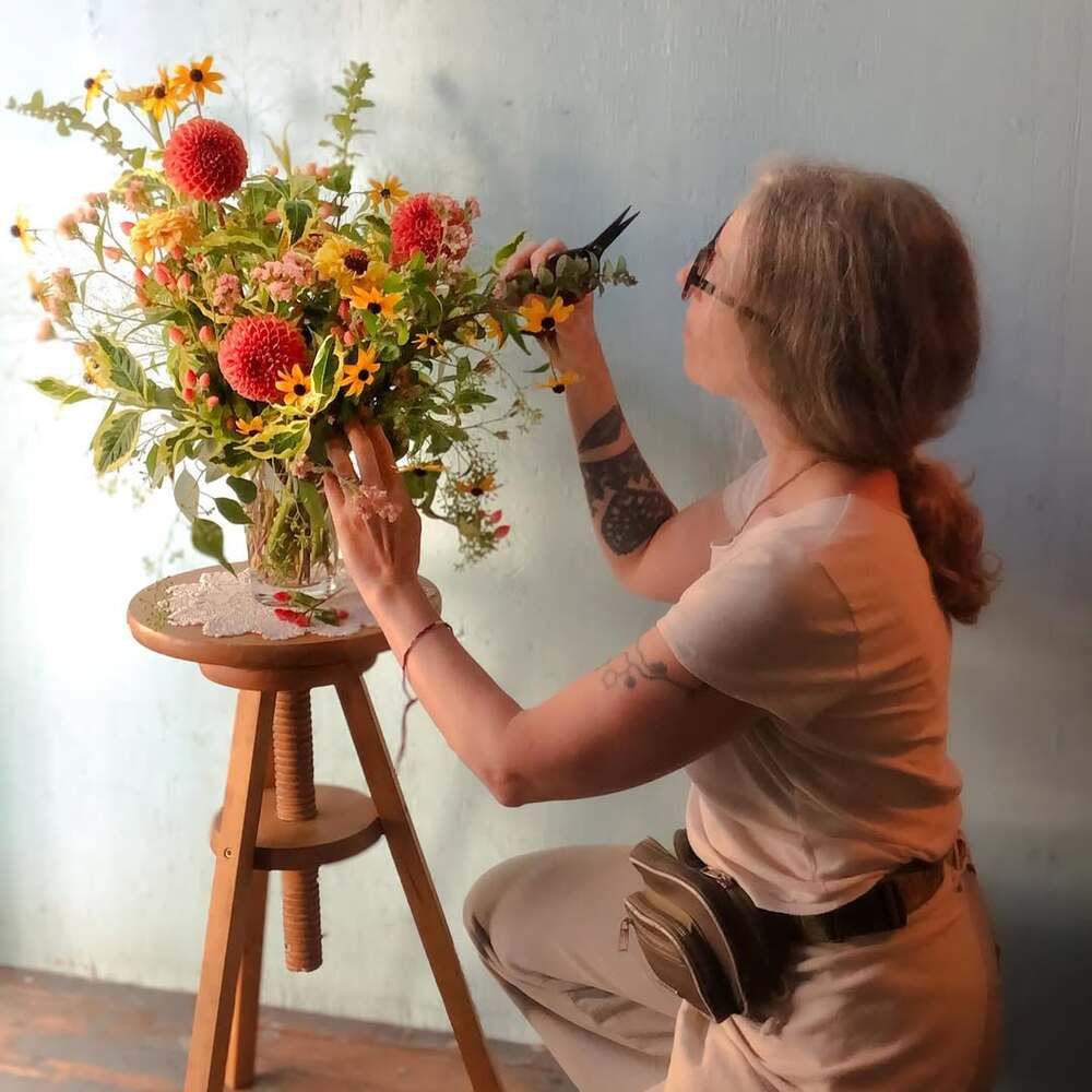 A florist pruning an arrangement