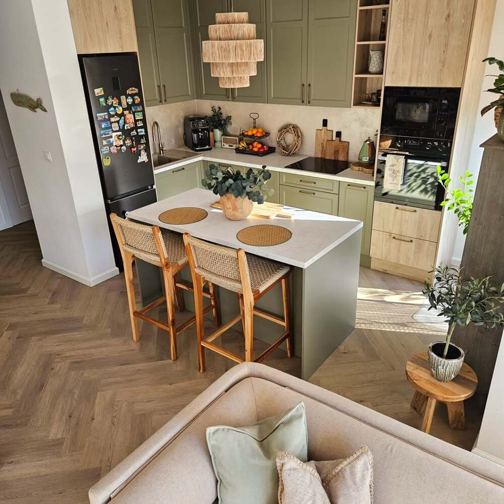 Green kitchen cabinets with indoor plants
