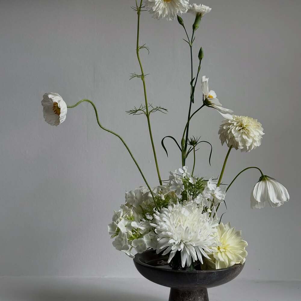 Minimalist white Japanese ikebana arrangement