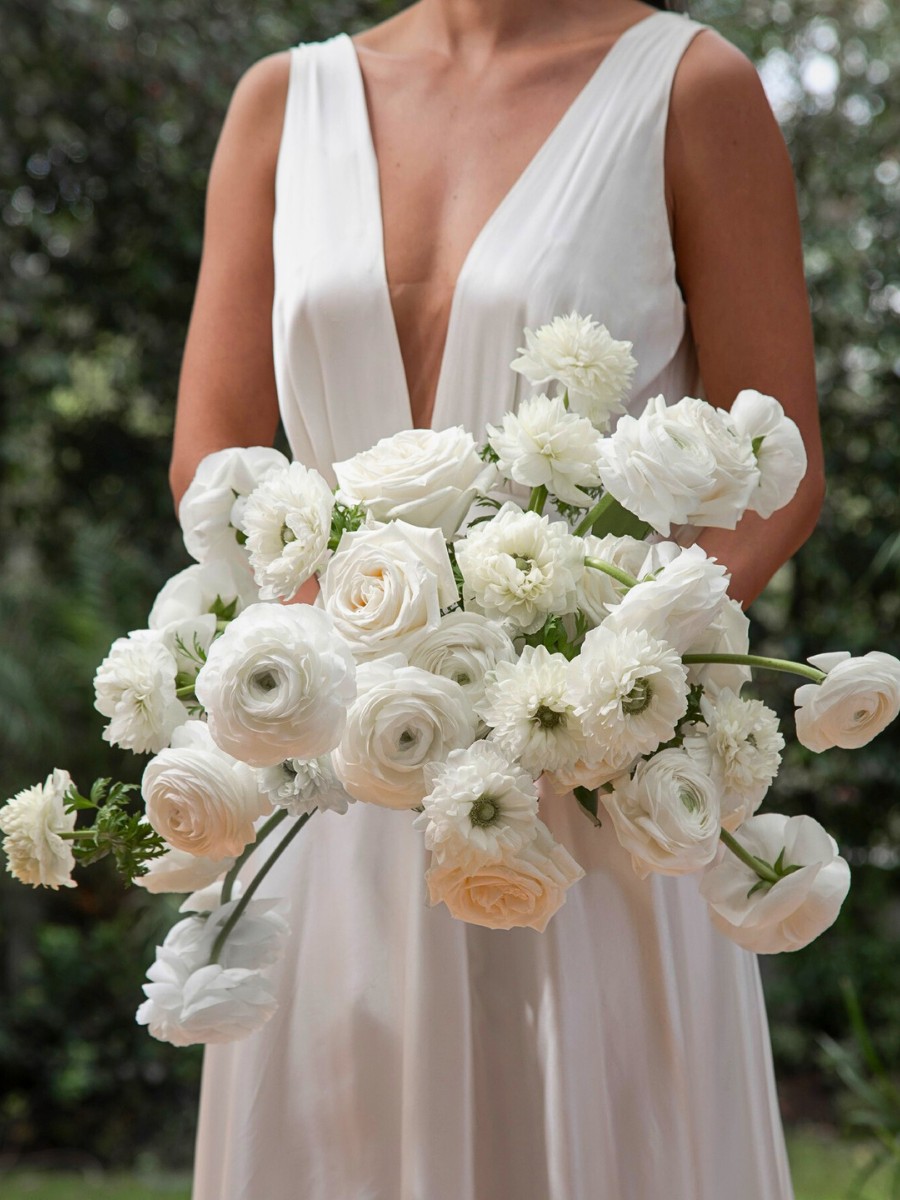 A bridal bouquet made with white roses and white flowers, by @rosaprimaroses