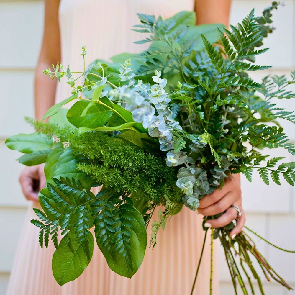 bridal bouquet featuring lots of greenery and small flowers