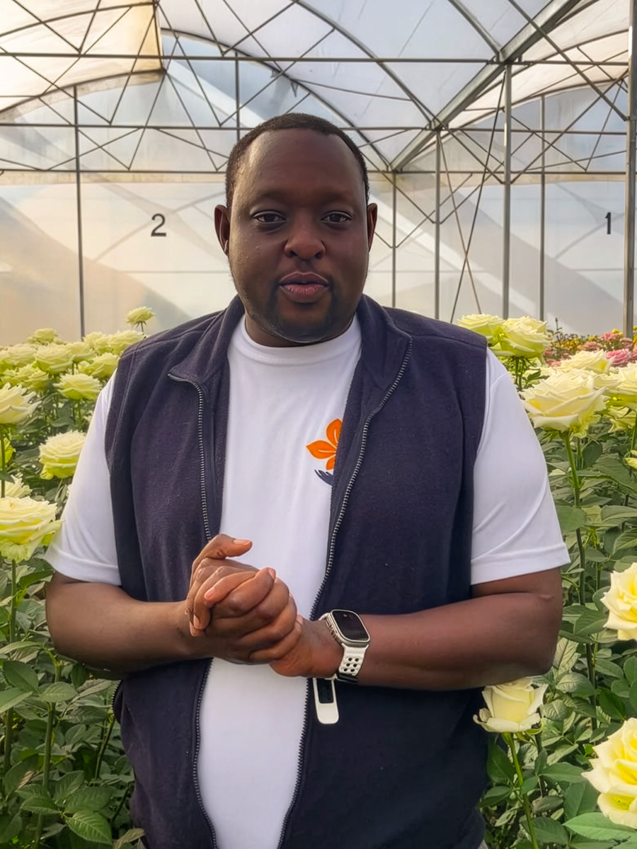 Ahmed Nzibo in United Selections greenhouse with white roses