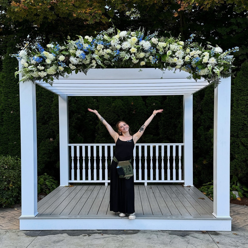 Florist showcasing floral art in wedding