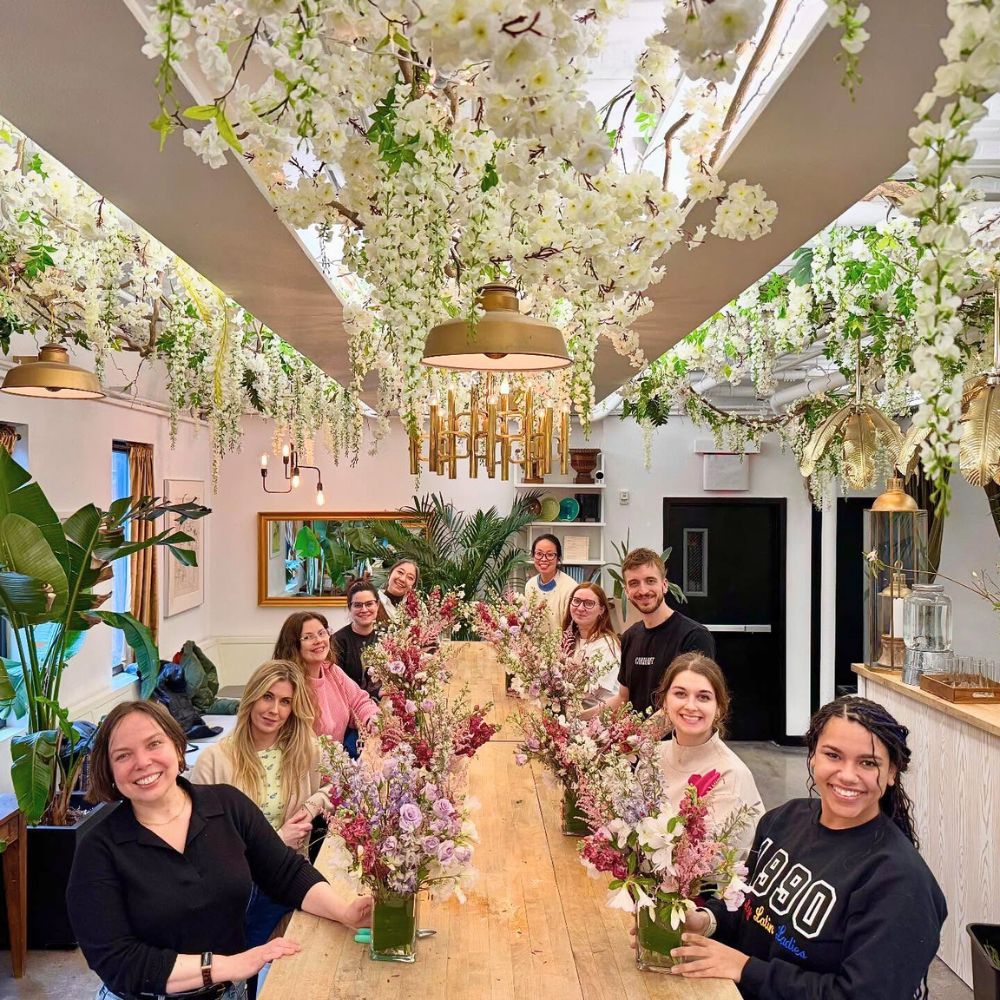 Students at FlowerSchool New York each with a bouquet they designed