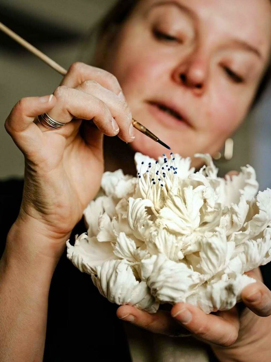 Anna Volkova artist working on a porcelain flower Anna Volkova artist working on a porcelain flower