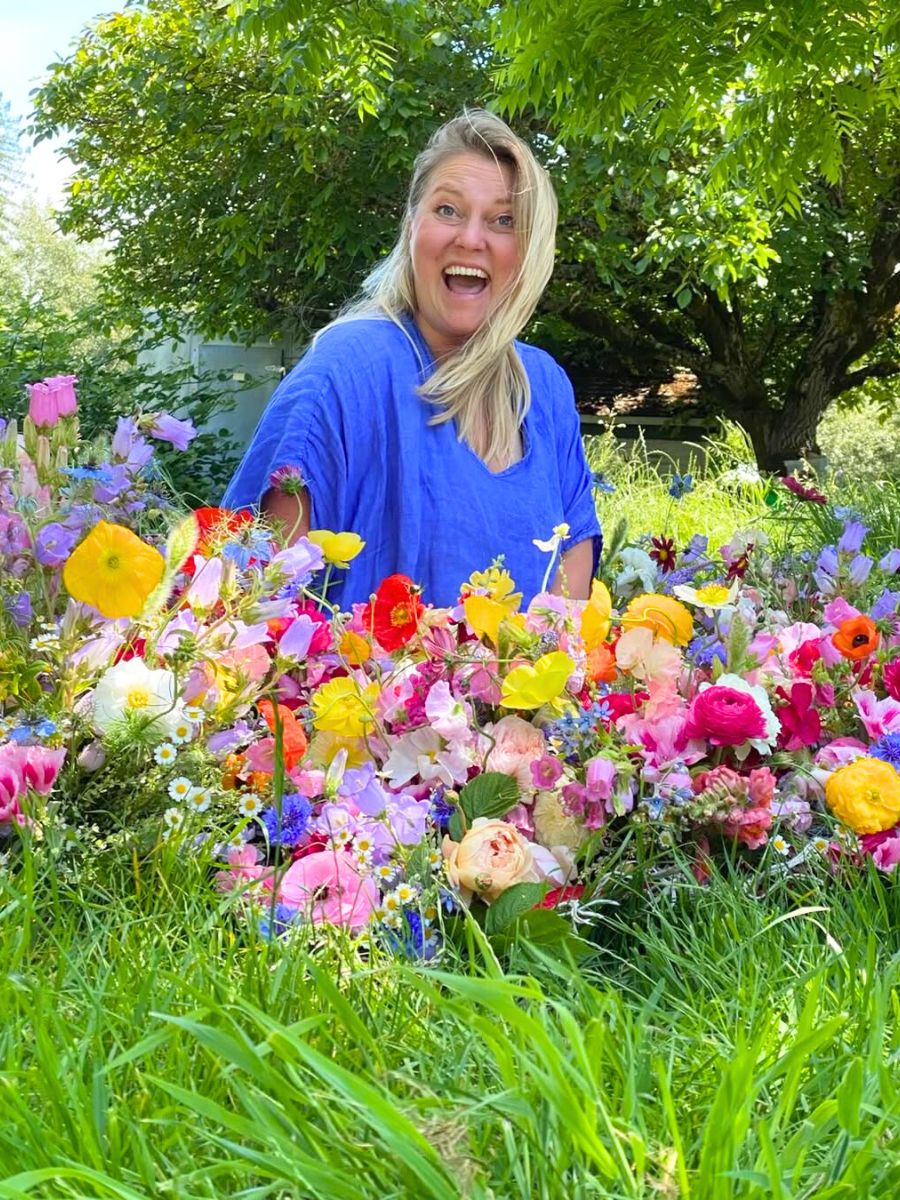 A woman in between spring flowers