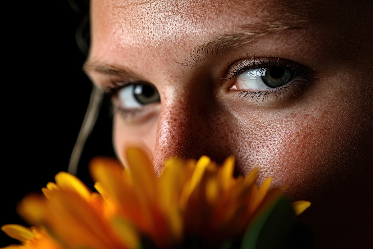 Woman smelling a yellow gerbera by Ahmad Juliyanto