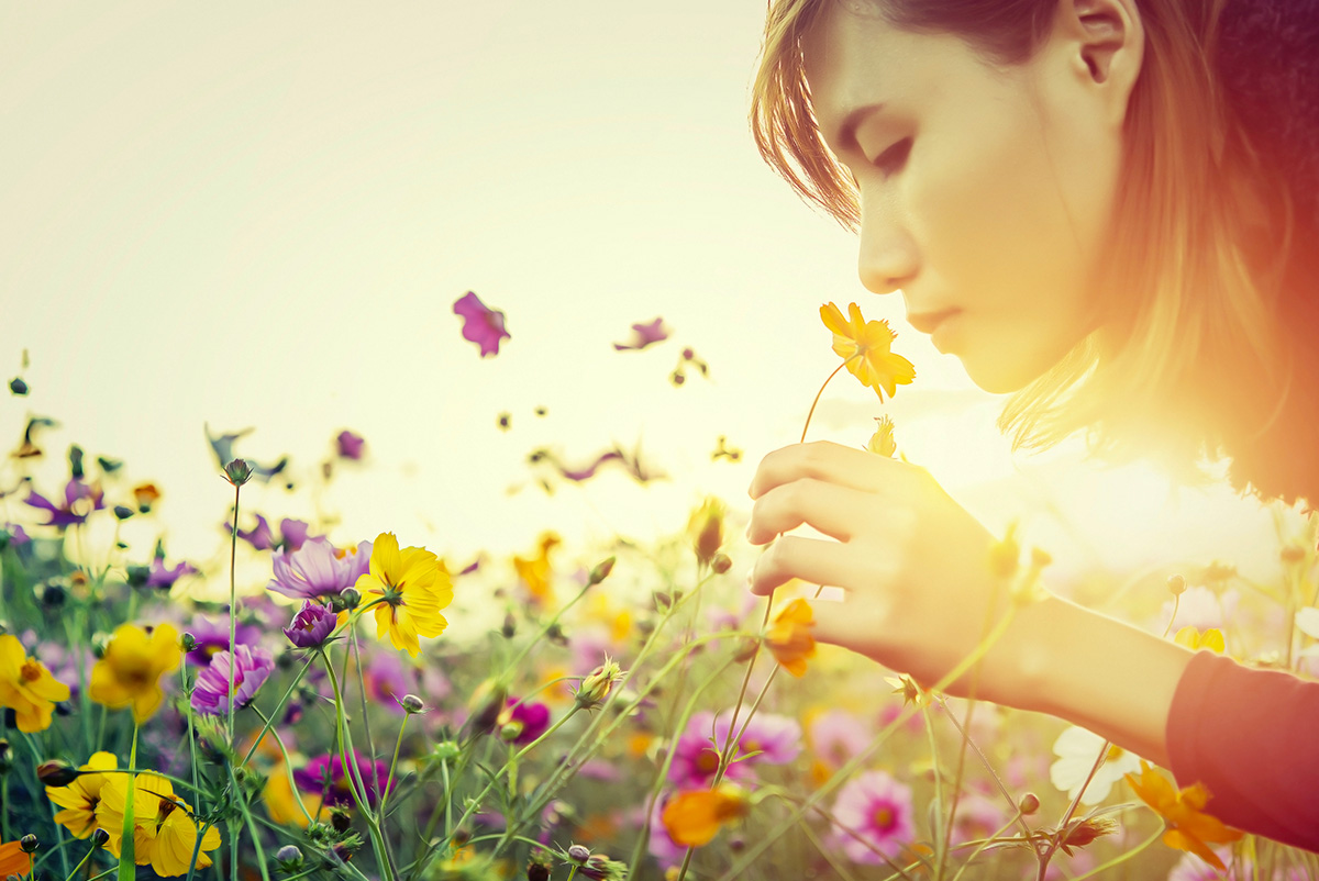 Woman smelling a wildflowers Prakasit Khuansuwan