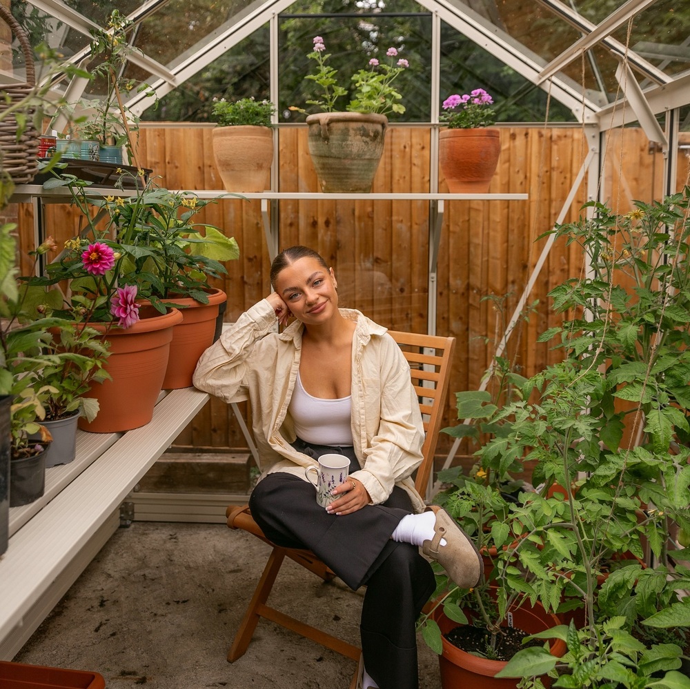 Lady seating under greenhouse