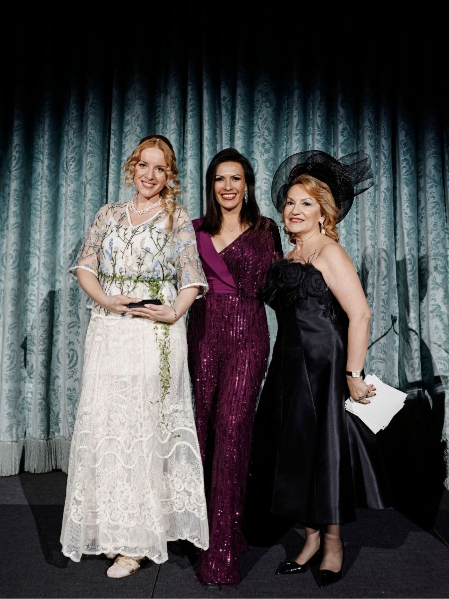 Katya Hutter holding her award, joined by Nadia Duran and Meltem Tepeler