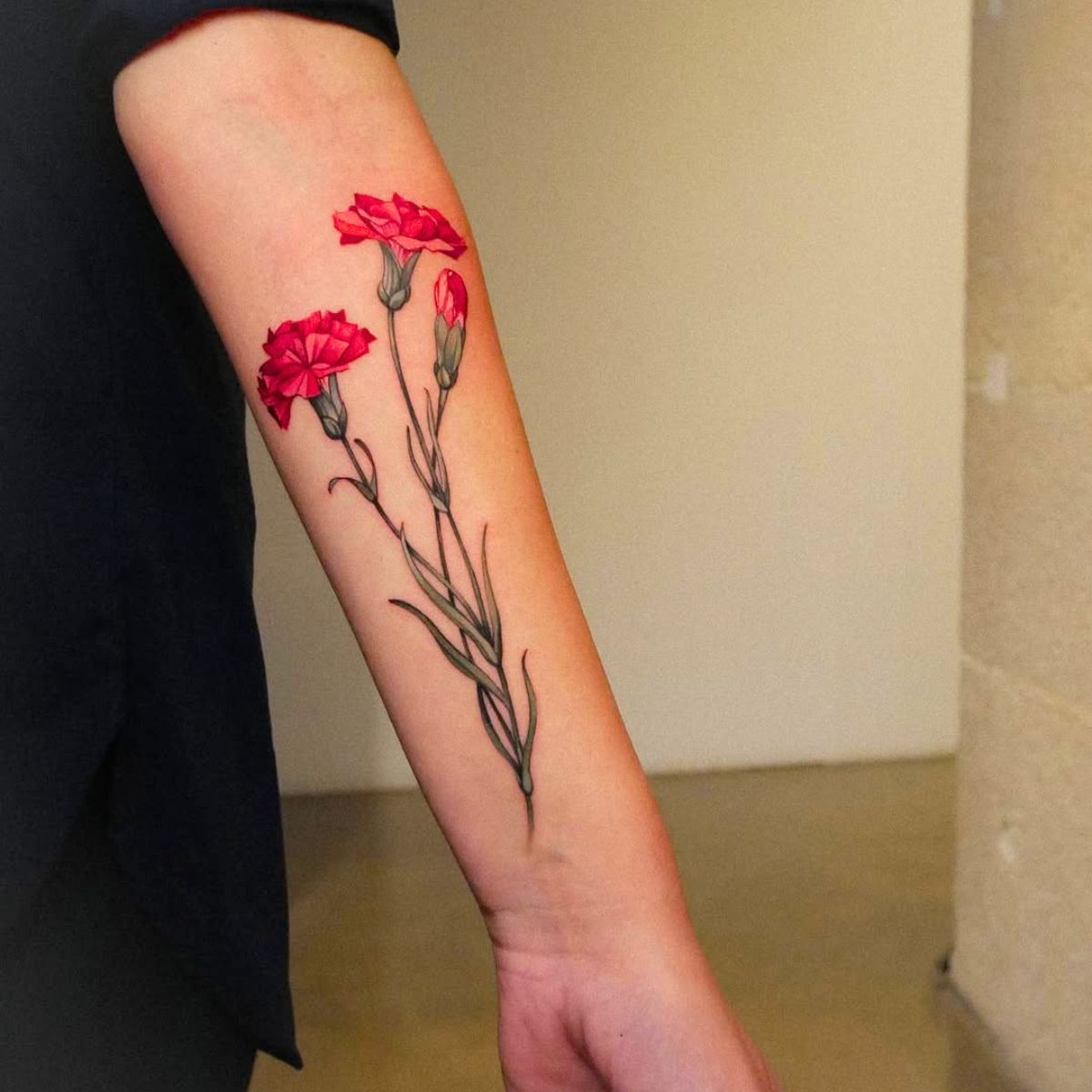 Red carnation tattoo on the arm