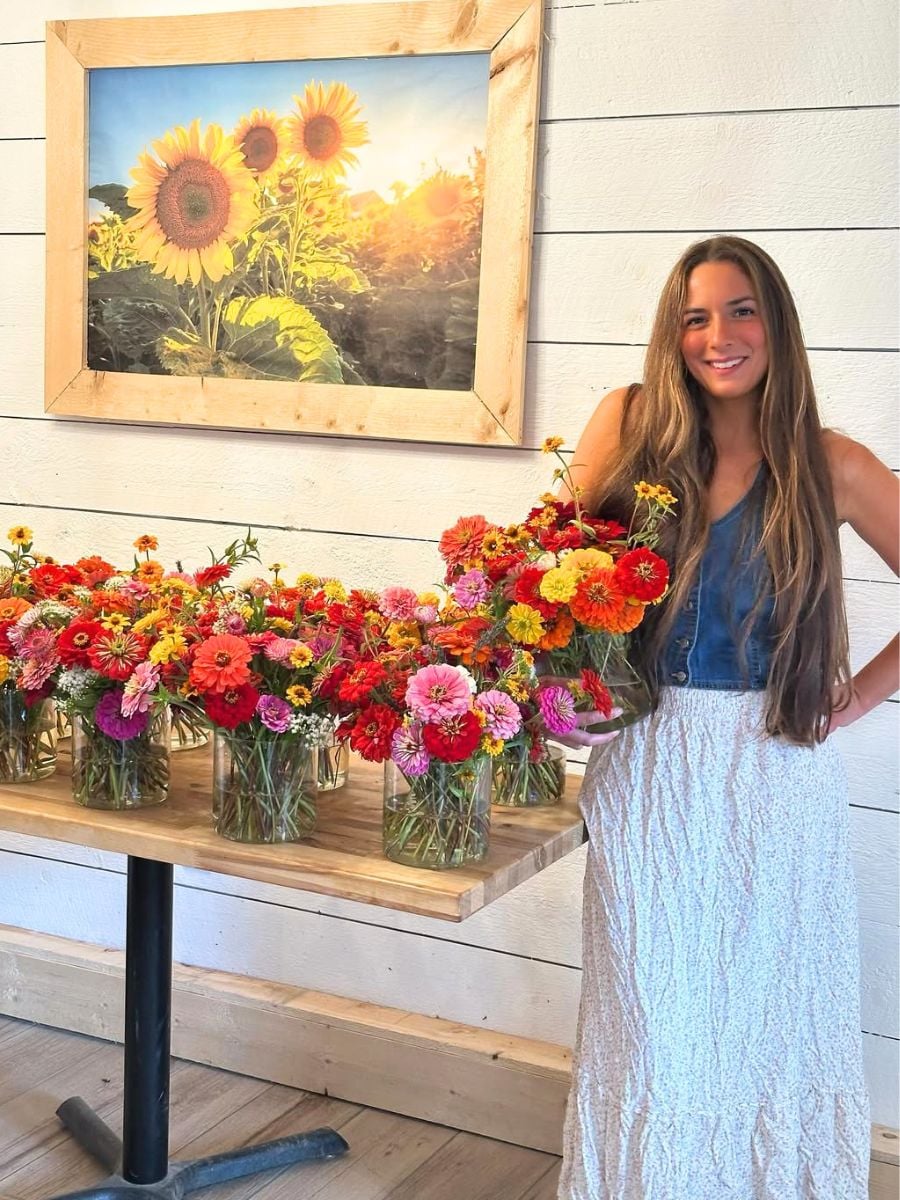 A girl with arrangements in glass vases
