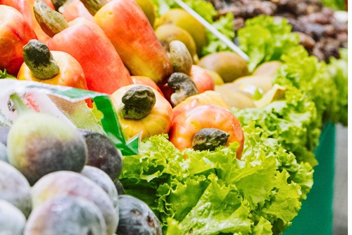 Colorful fresh fruits and vegetables on display in a busy indoor market