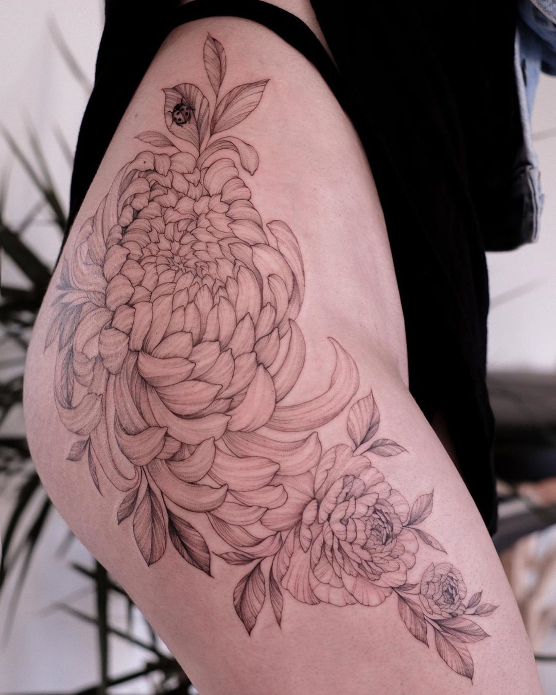 Black flower tattoo by sasha tattooing