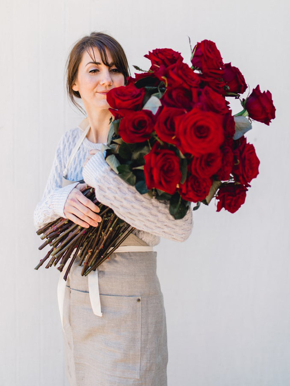 luxury red roses with girl smelling