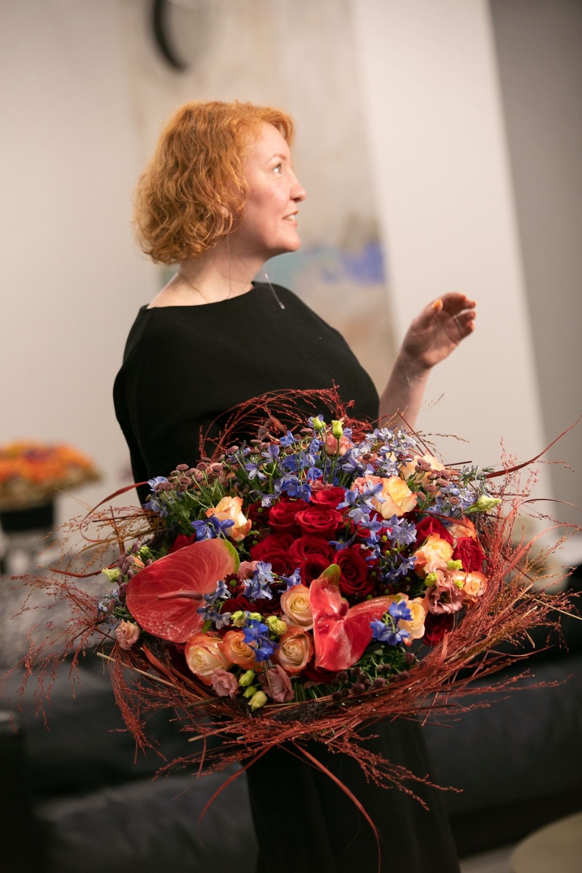 Red haired women next to flowers