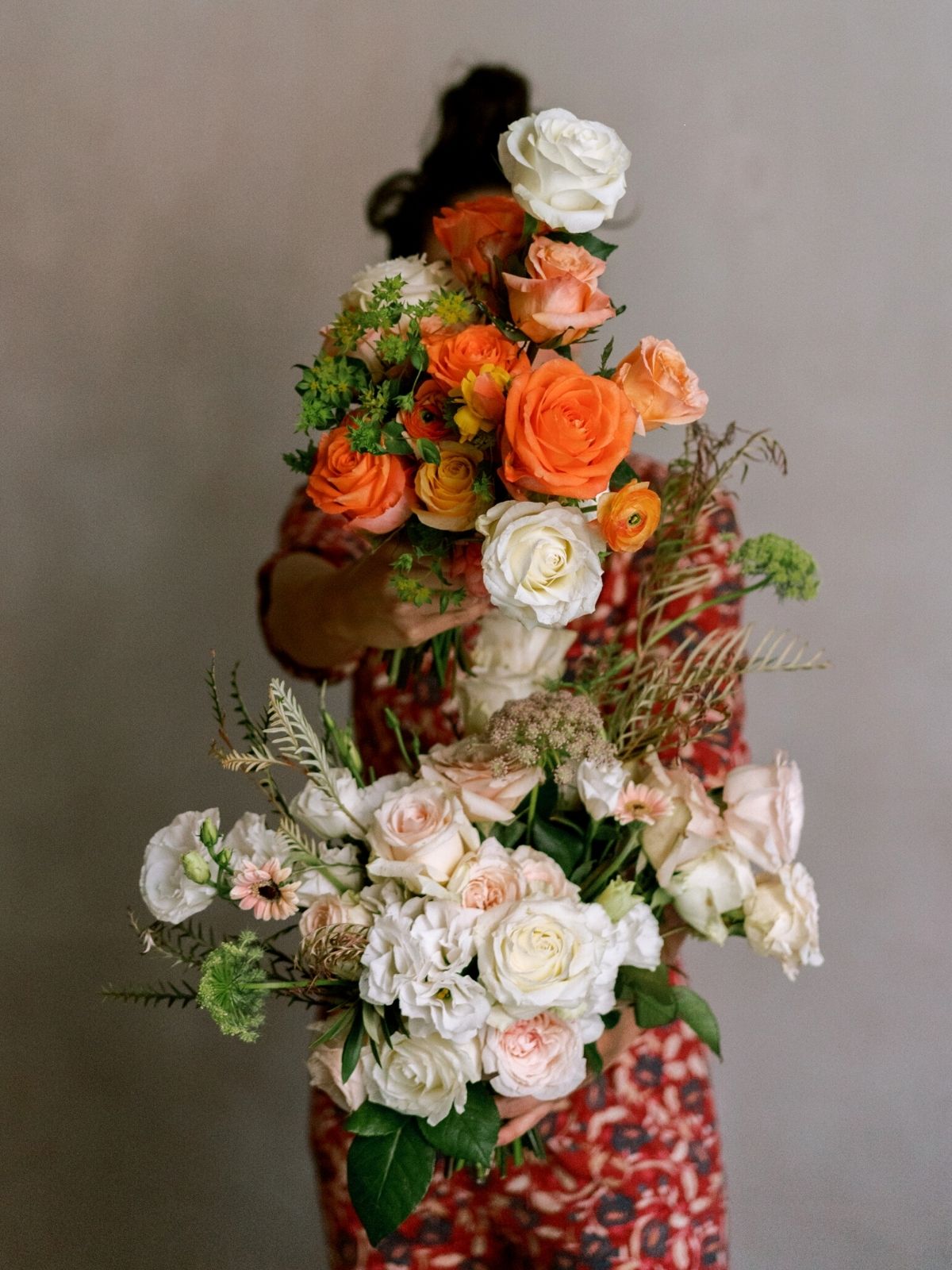 Courtesy Del Cabo Event / Aria Vera - Yamile Bulos hidden behind a bunch of blush and orange flowers - on Thursd