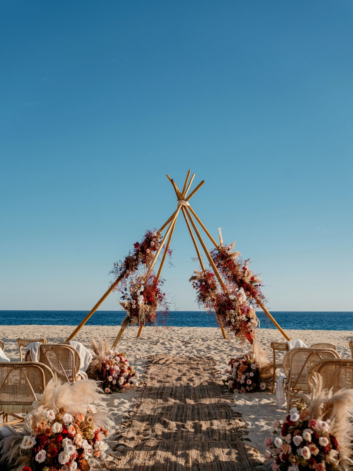 Warm colored triangle arch for a wedding at Aria Vera Cabo - on Thursd