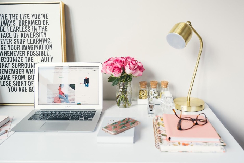 Study table with MacBook and flowers