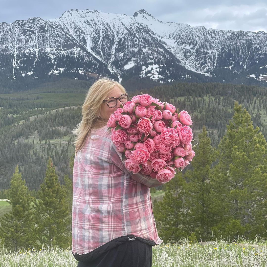 Holly Heider Chapple with a bouquet of Peonies, grown at Hope Flower Farm, in Evan's shirt.... - on Thursd