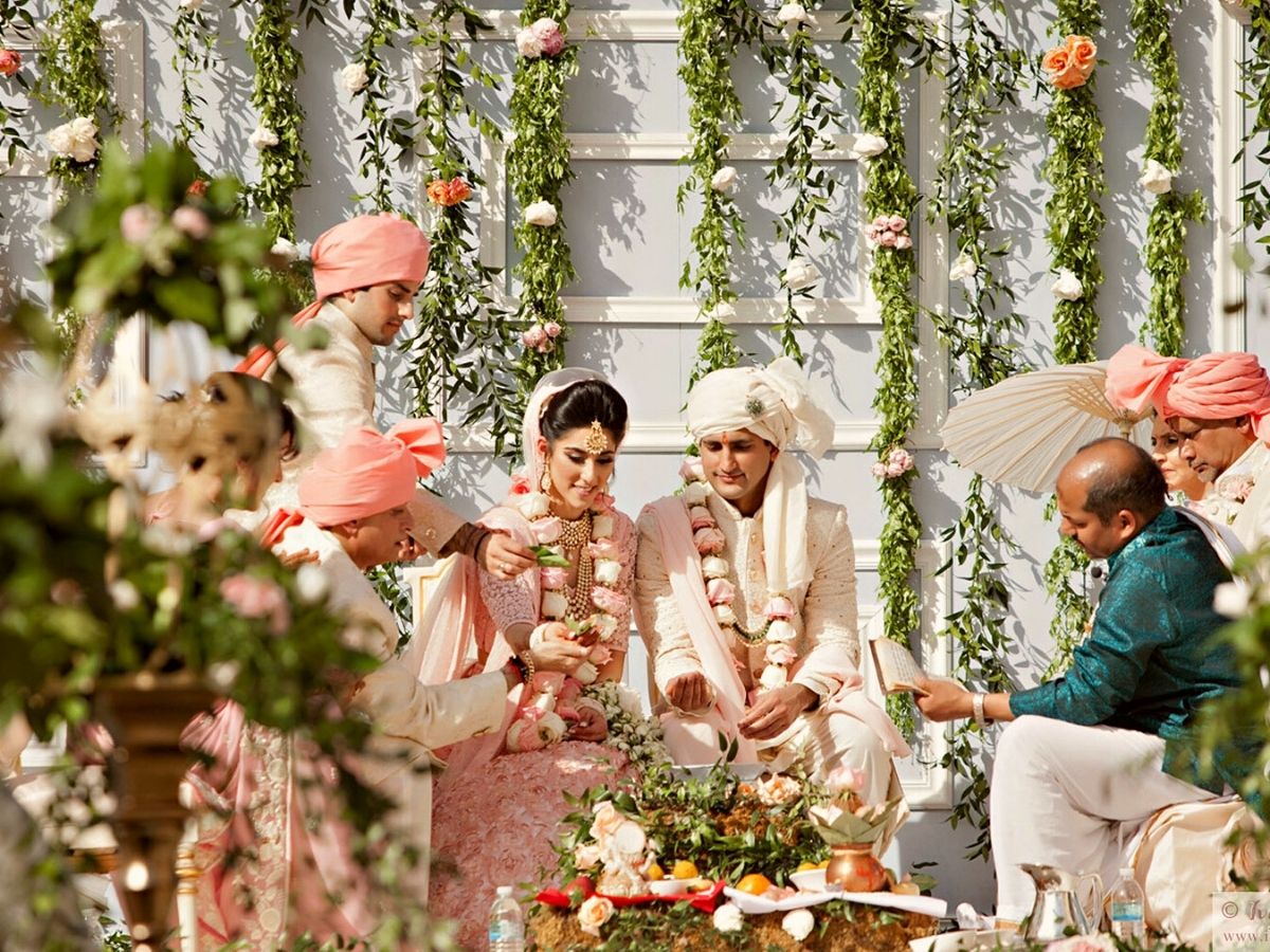 Wedding partners using a neutral tone Indian Garland on Thursd