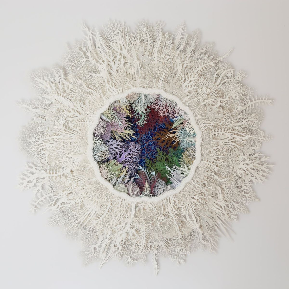 Rogan Brown cuts coral paper sculptures to illustrate coral reefs in danger on Thursd