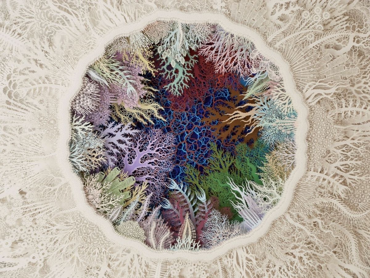 Rogan Brown cuts coral paper sculptures to create awareness in the care of coral reefs on Thursd
