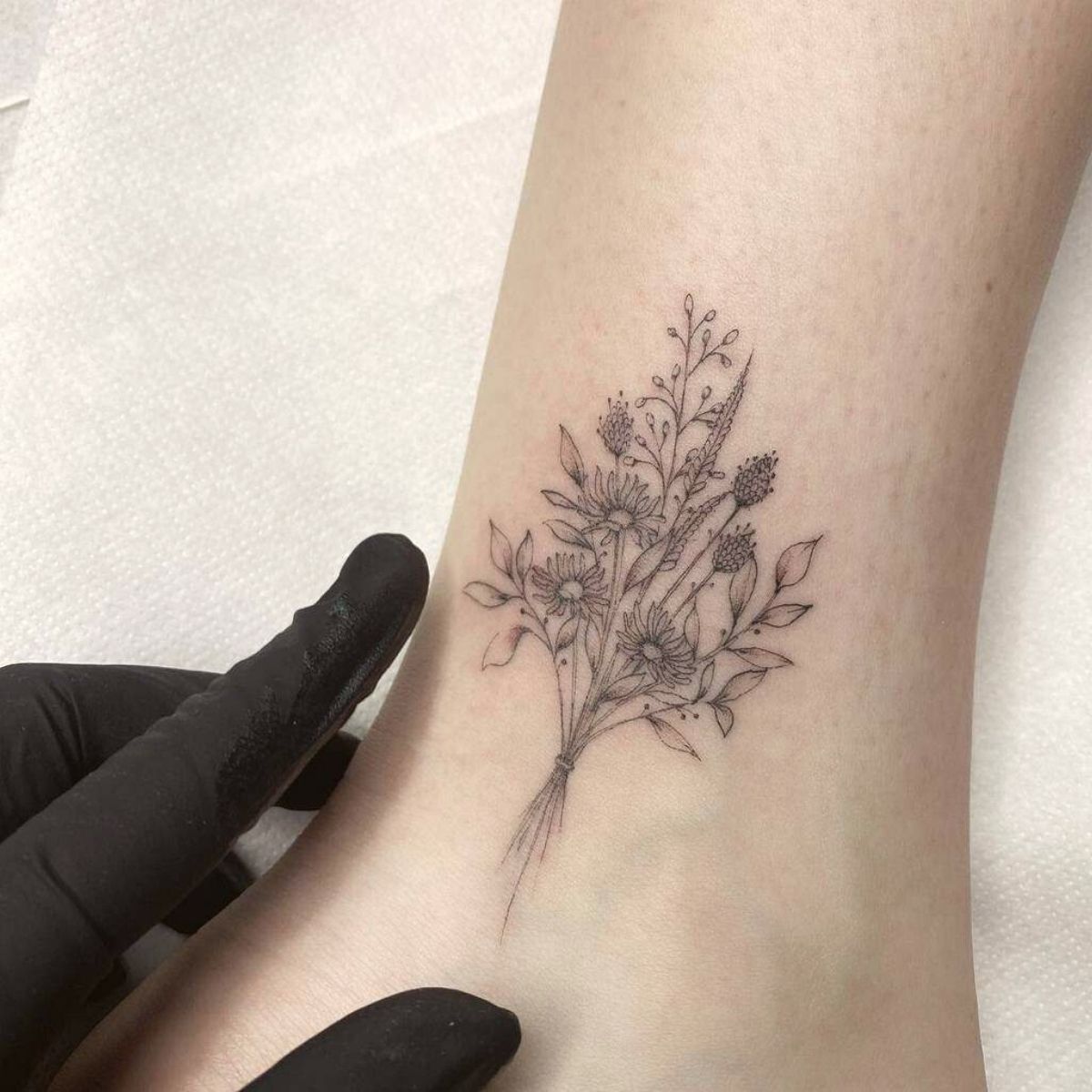 A tattoo of a small plant growing through a rock Made by Richard Blackstar  from Sundance Tattoo Studio located in  Plant tattoo Tattoos Abstract  flower tattoos