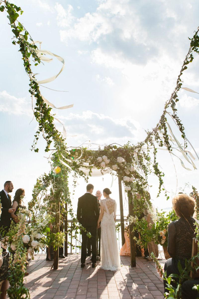 Mixing different styles of flowers and colors for a wedding arch on Thursd